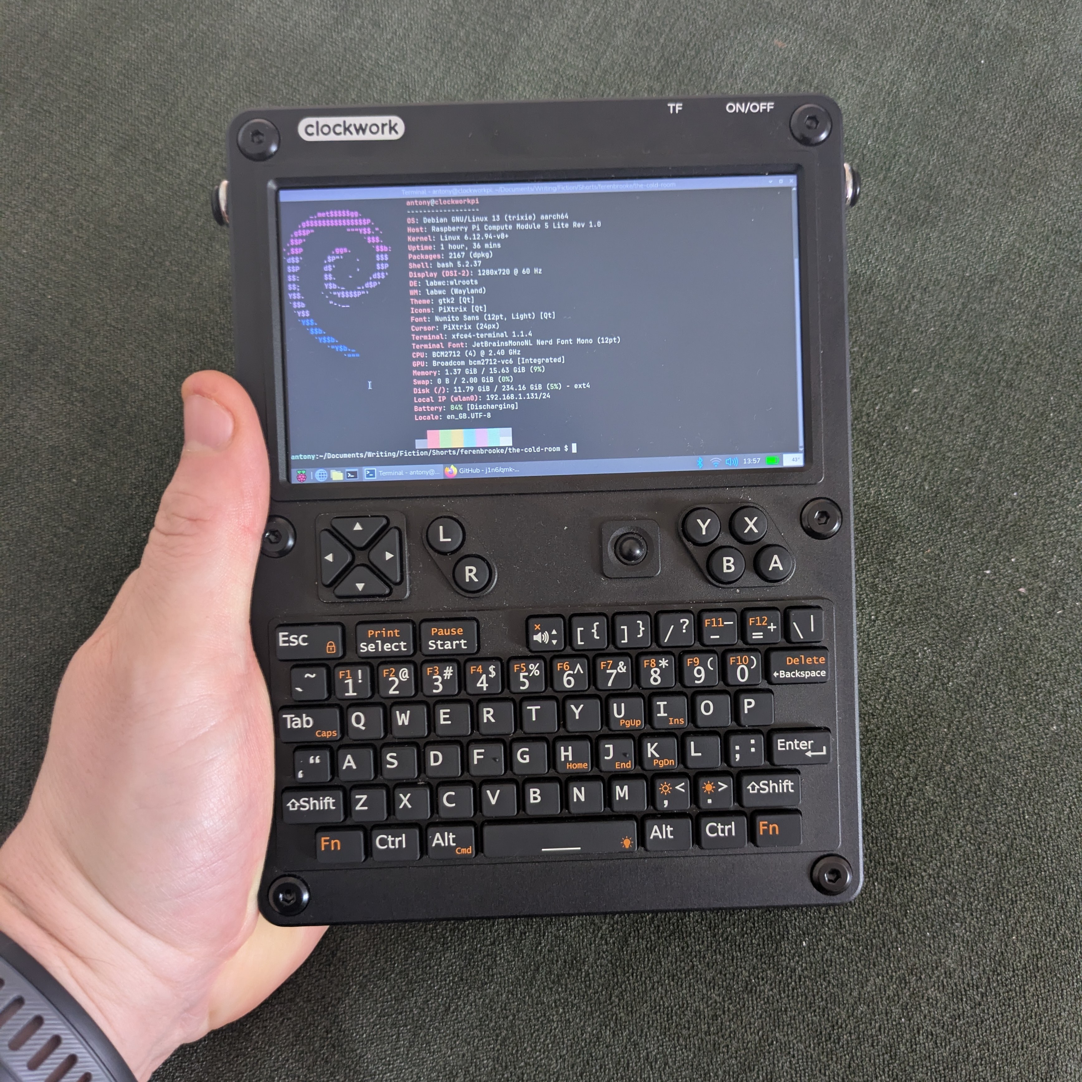 A photo of the Clockwork Pi uConsole in the hand of the author.
